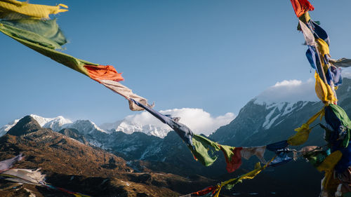 Low angle view of snowcapped mountains against sky