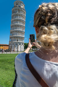 Portrait of woman photographing with mobile phone