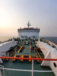 Ship in sea against sky during sunset