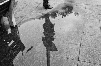 Low section of people walking on wet street