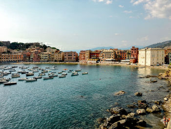 Buildings by sea against sky in city