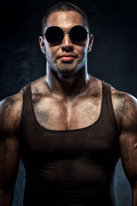 Portrait of confident muscular worker wearing sunglasses