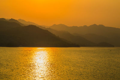 Scenic view of lake against sky during sunset