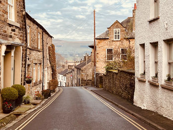 Empty road by building