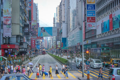 People on city street amidst buildings