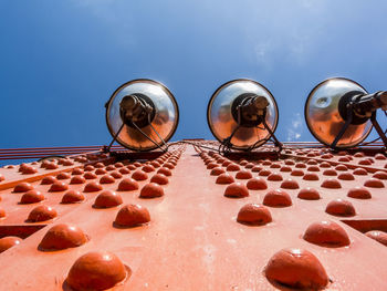 Low angle view of pastries against blue sky