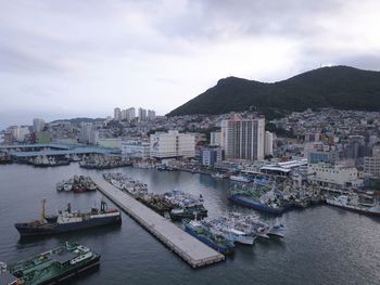 High angle view of bay and buildings against sky