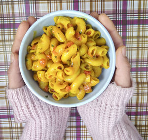 Directly above shot of person holding food in bowl