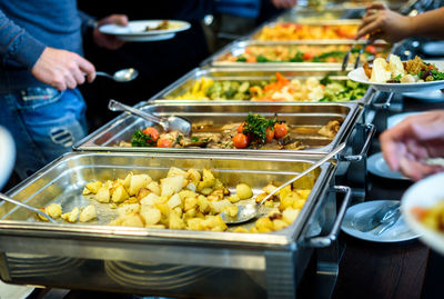 Cropped image of hands taking food