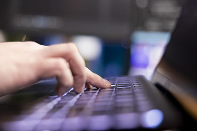 Cropped hand using laptop