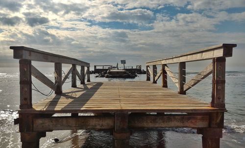 Pier over sea against sky