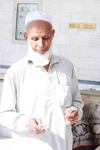 Senior man holding dentures