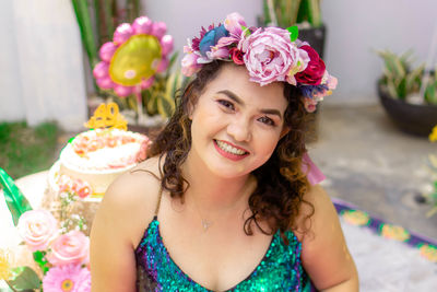 Portrait of happy woman with red flower