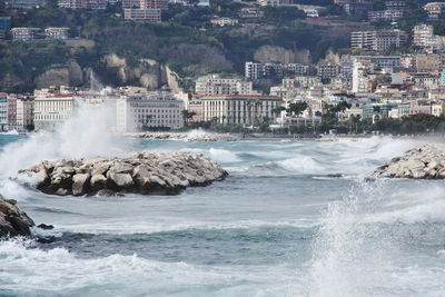 Panoramic view of sea and city against sky