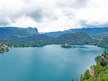 Scenic view of sea and mountains against sky