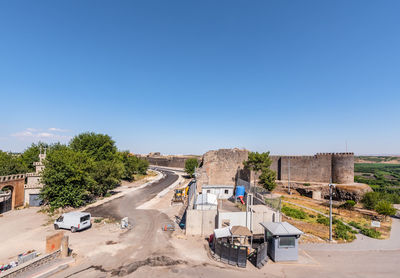 View of construction site against clear blue sky