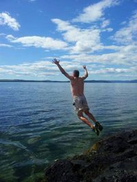 Woman jumping in water