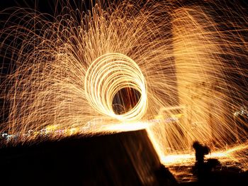 Low angle view of firework display at night