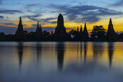 Reflection of buildings in city at sunset