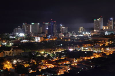 High angle view of illuminated buildings against sky at night