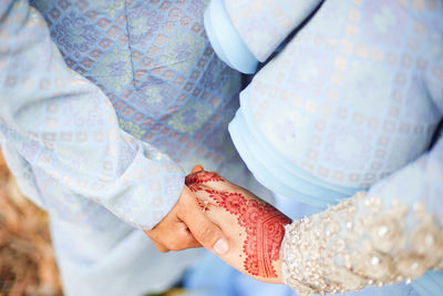 Midsection of woman holding umbrella