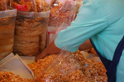 Midsection of man at market stall