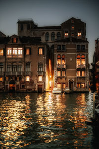 Reflection of illuminated buildings in canal at night