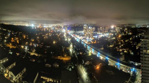 High angle view of illuminated city buildings at night