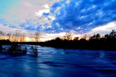 Scenic view of lake at sunset