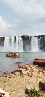 Scenic view of waterfall against sky