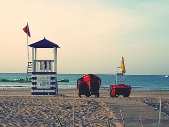 Lifeguard hut on beach against clear sky
