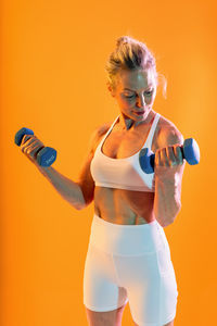 Side view of woman exercising in gym