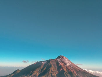 Scenic view of mountains against clear blue sky