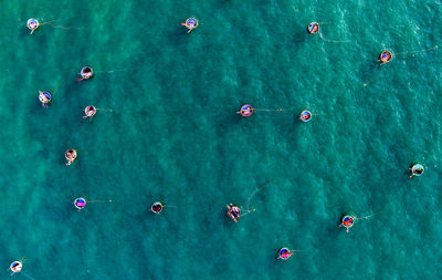 High angle view of people swimming in sea