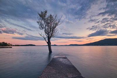 Scenic view of lake against sky during sunset