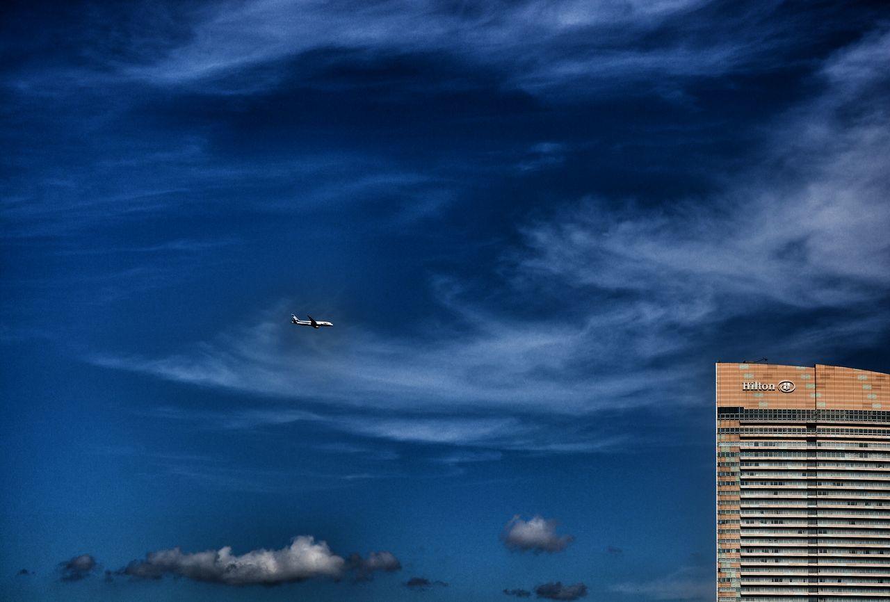 sky, low angle view, cloud - sky, building exterior, architecture, built structure, cloudy, weather, cloud, dusk, building, outdoors, blue, city, no people, storm cloud, nature, overcast, silhouette, dramatic sky