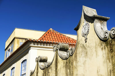 Low angle view of built structure against clear blue sky