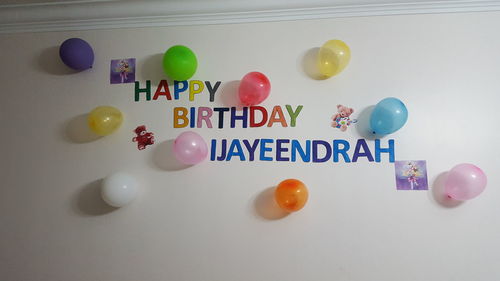 Low angle view of colorful decorations hanging on wall during birthday party