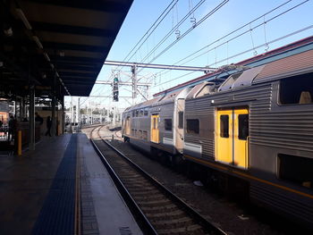 Train at railroad station against sky