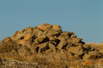 Rock formations against clear blue sky