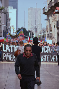 Full length portrait of man standing on street in city