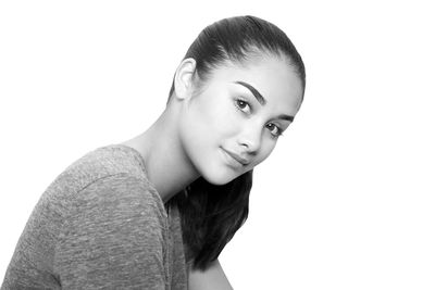 Portrait of smiling young woman against white background