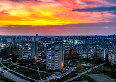 High angle view of illuminated buildings against sky during sunset