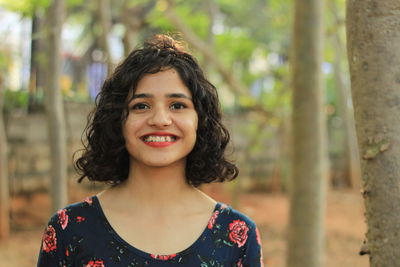 Portrait of smiling woman standing outdoors