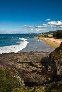 Scenic view of beach against blue sky