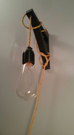 Close-up of light bulb hanging 