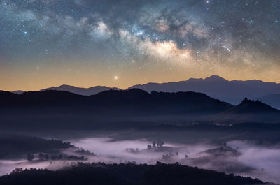 Scenic view of mountains against sky at night