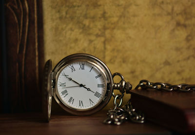 Close-up of pocket watch on table