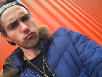 Close-up of young man wearing blue jacket during winter