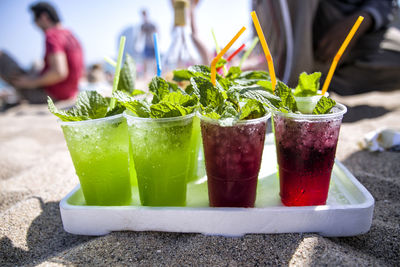 Close-up of drinks on beach